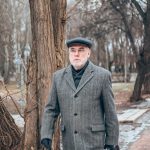 Stylish gentleman wearing timeless menswear in the city.